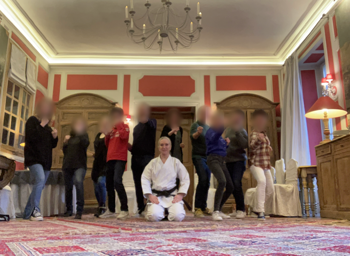Groupe en position de karaté dans un salon de séminaire