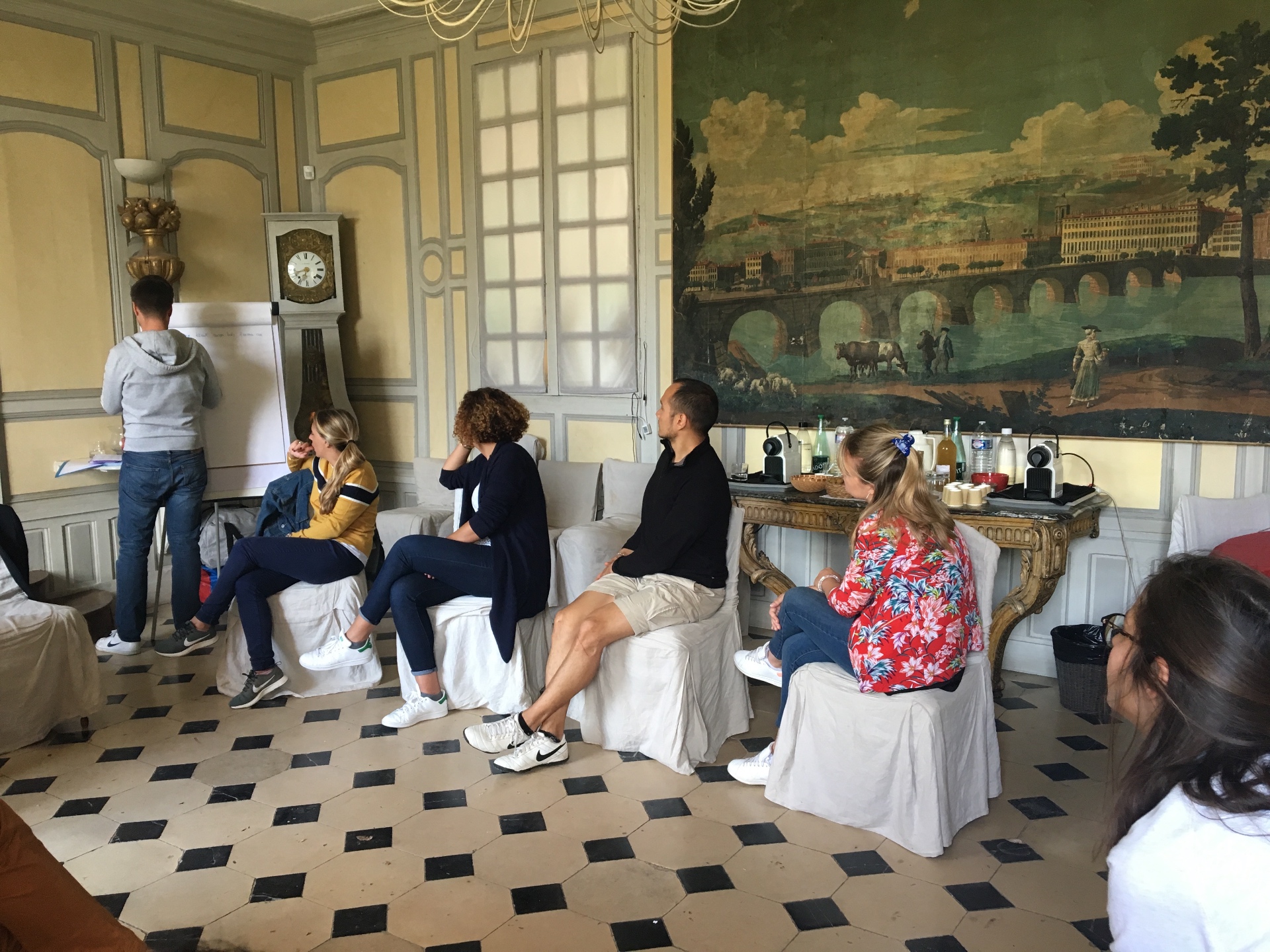Groupe assis dans un salon de séminaire en discussion avec Caroline Desmazures